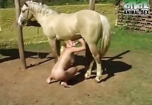 Golden hottie is enjoying oral sex with a horse