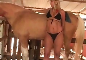 Cowgirl in hat is having sex with a stallion
