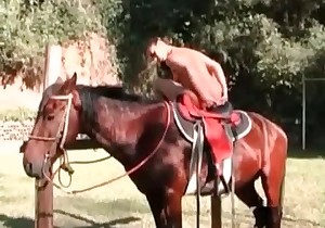 Sexy woman is stretching her ass on a horse